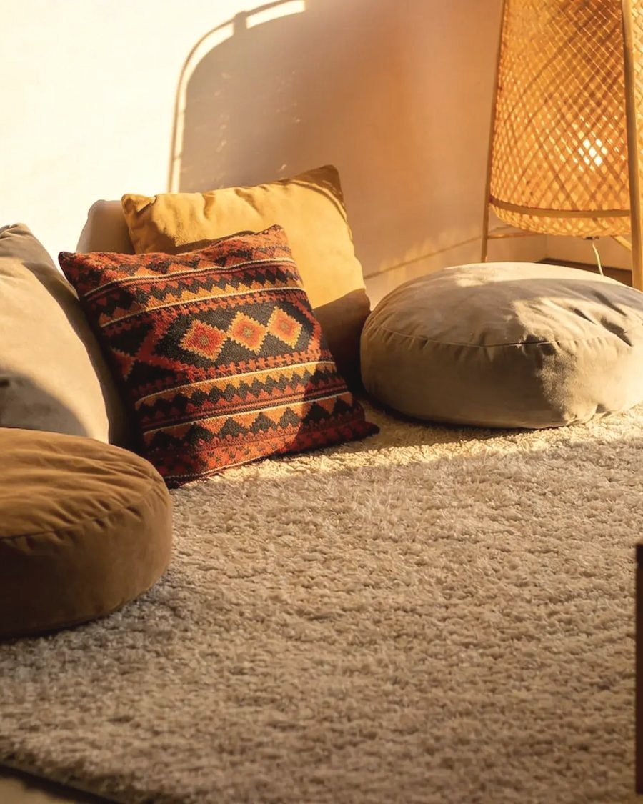A cosy living corner with handmade cushions and soft textile pieces