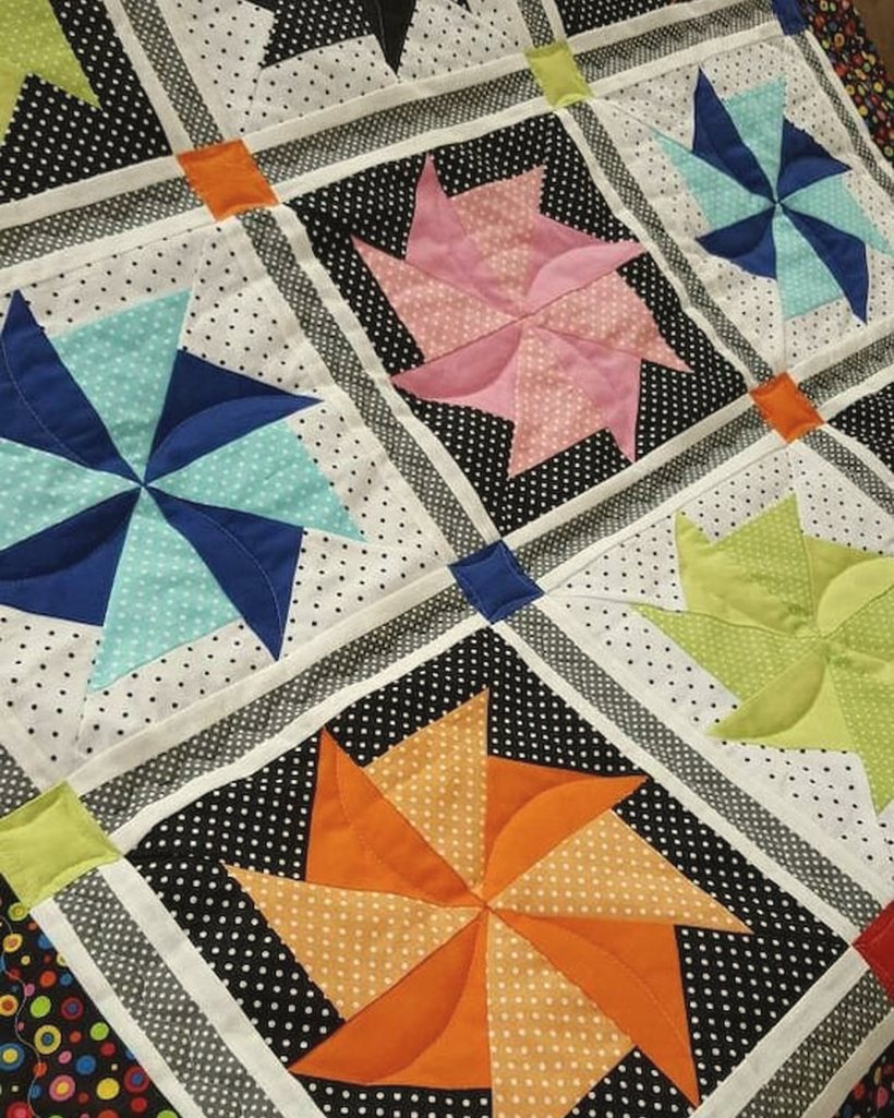 A custom quilt made from clothing, photographed outdoors